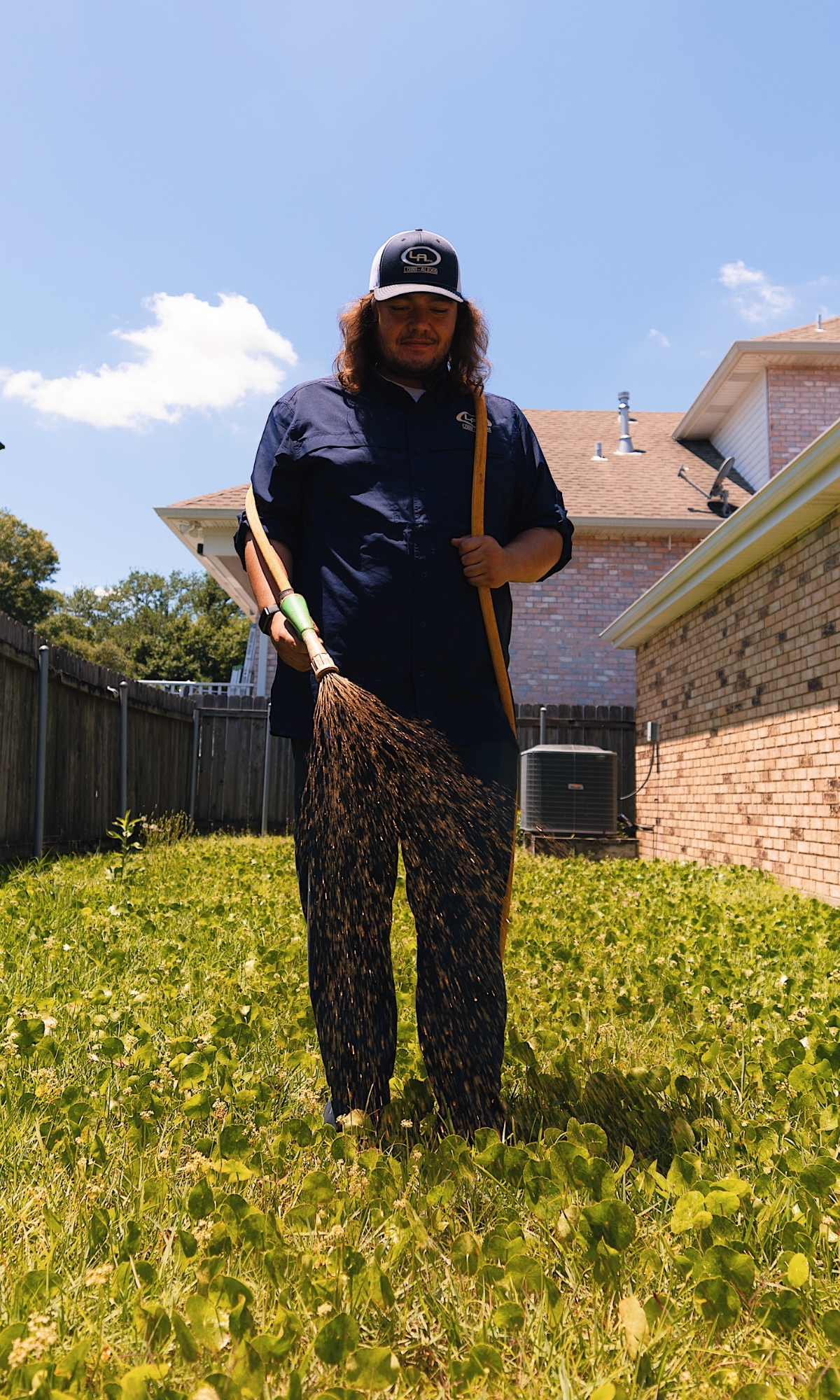 Man spraying chemical solution on lawn